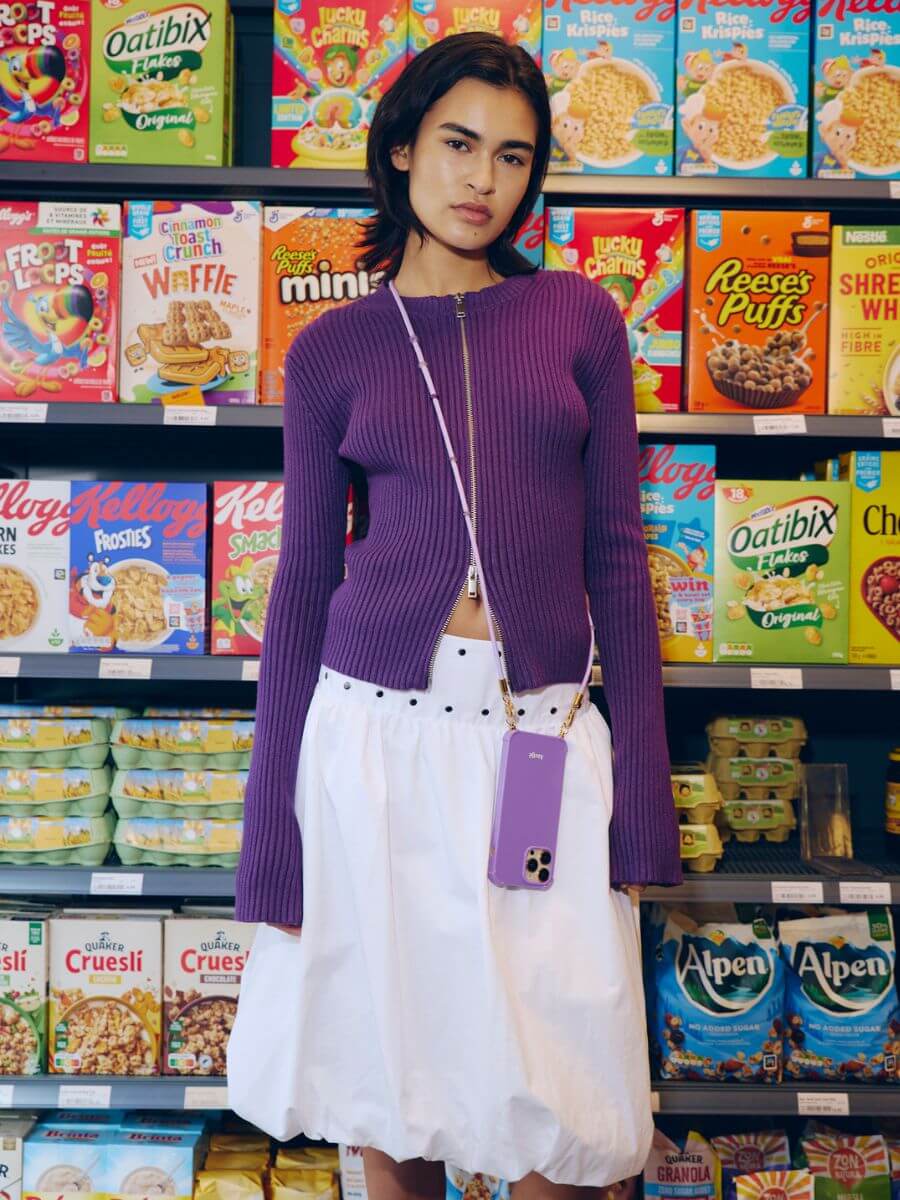 Atelje iphone case violet with long cord in ultraviolet worn cross body over purple zip cardigan and white bubble skirt