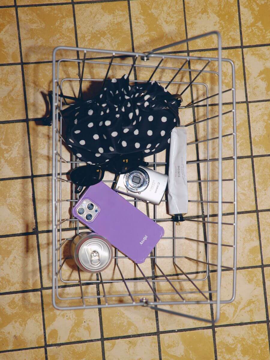 Atelje iphone case violet in shopping basket with polka dot bag, sunglasses, digital camera and other accessories