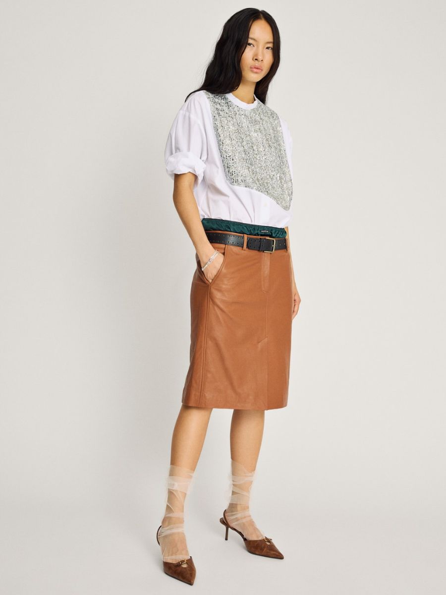 Munthe - Nayel Shirt - White Mix styled with sleeves rolled up to short sleeves, tucked into layered satin green skirt and brown leather skirt with black belt, brown pointed toe, kitten heel slingbacks and white organza socks
