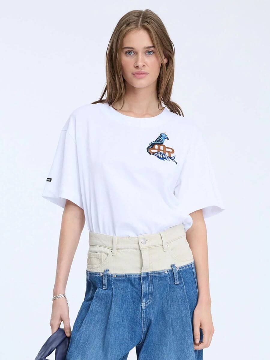 Munthe - Nuri T-Shirt tucked into wide leg, mid-blue jeans with a cream denim waistband