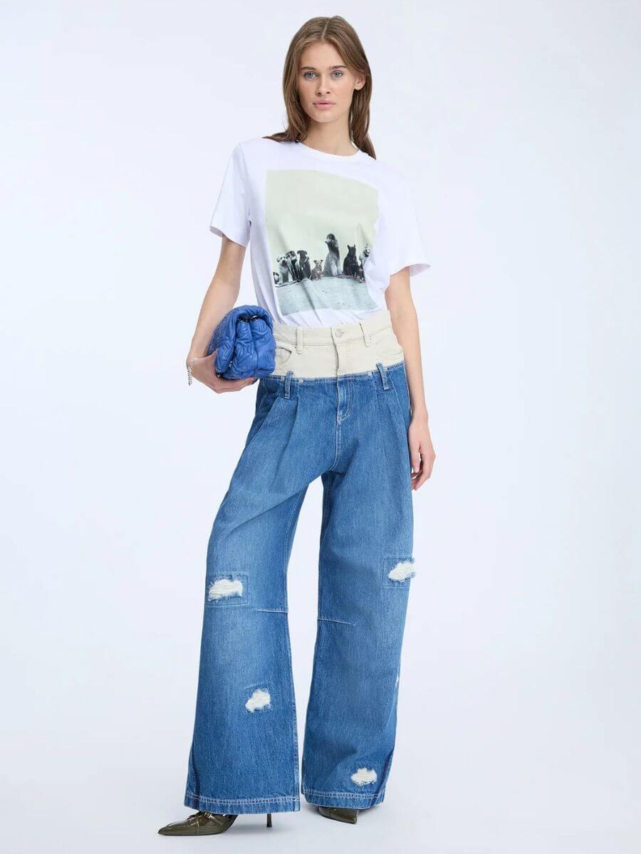 Munthe - Nyla T-Shirt tucked into wide leg mid blue jeans with cream waistband, blue leather clutch bag and patent leather pointed toe heels
