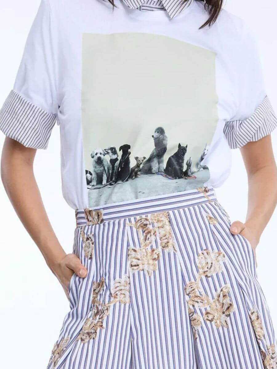 Munthe - Nyla T-Shirt styled layered over a white/grey pink stripe shirt with the sleeves rolled up and tucked into a striped cotton skirt