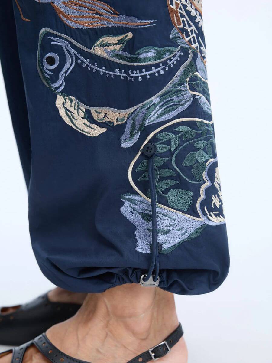 Munthe - Unform Pants - Navy - zoom in of button detail at hem to stop drawcord from dangling