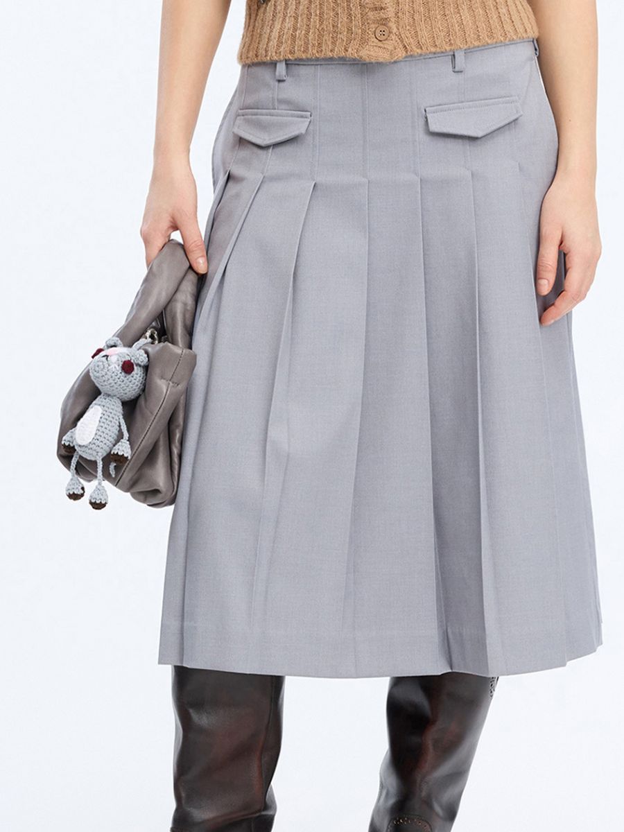 Munthe - Vamke Bag Charm on grey leather bag with grey pleated skirt, boots and Vocca cardigan