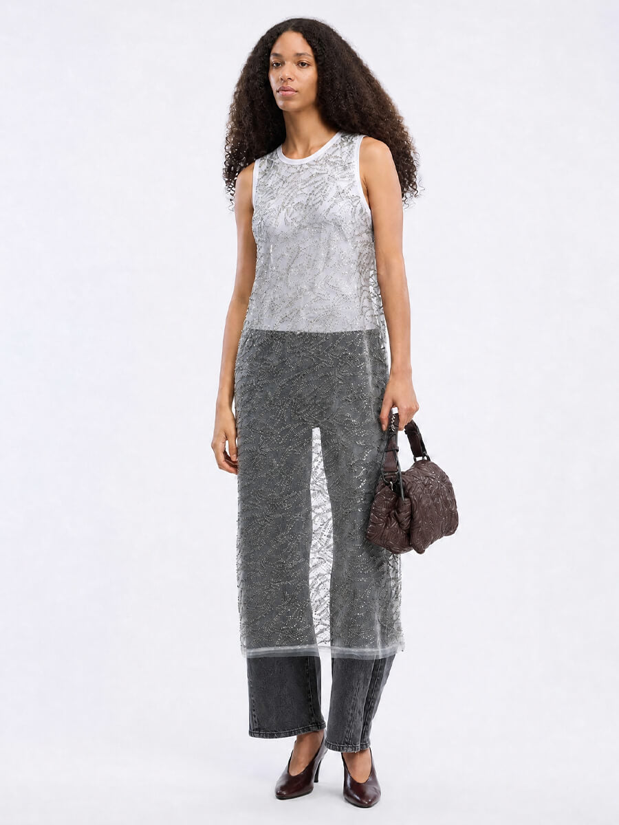 MUNTHE Varika Dress worn over white tank top, grey barrel leg jeans, heels and embossed leather handbag