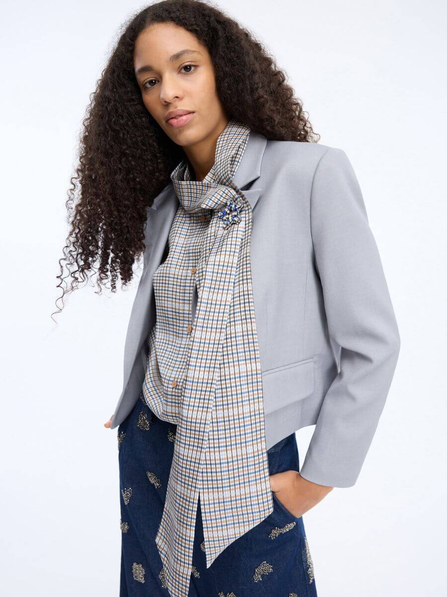 Munthe Veiling Shirt styled tucked into jeans with grey blazer and diamante brooch pinning the tie closed
