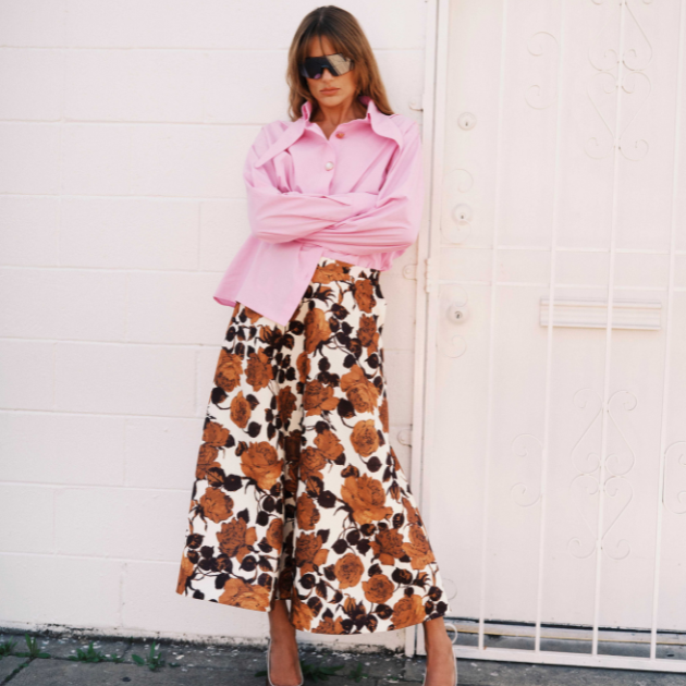Model in Essentiel Antwerp floral skirt and pink blouse