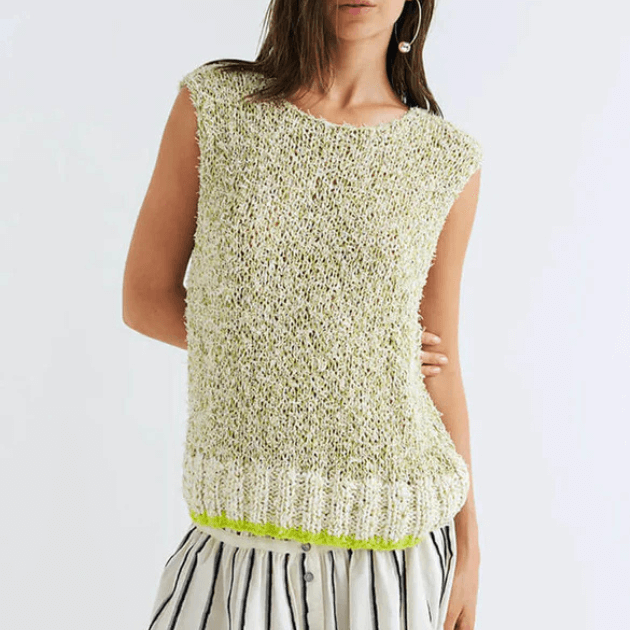Woman wearing a light green knitted Dawn x Dare sleeveless knit vest on a white background
