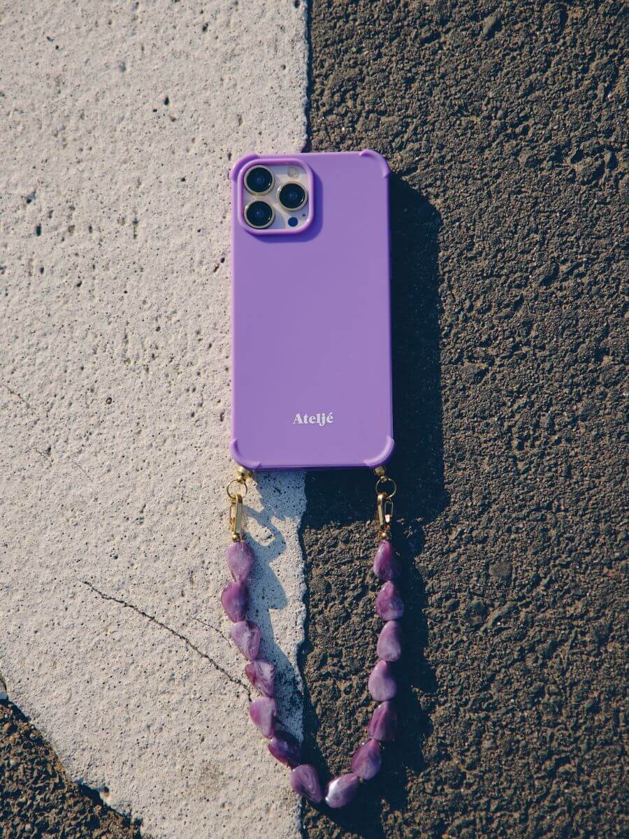 Atelje iphone case violet with Orchid short cord on tarmac