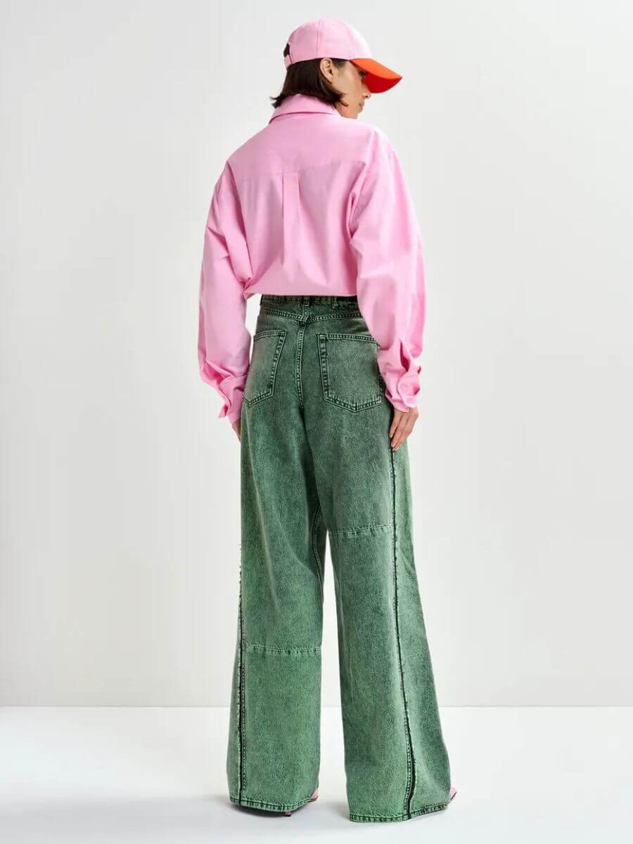 Essentiel Antwerp Jomato Shirt in Cotton Candy pink styled with pink/orange cap and grey wide leg jeans, back view