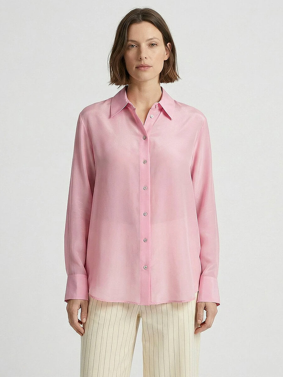 Woman wearing MINUS Caty Silk Shirt in pink with cream pin stripe relaxed trousers