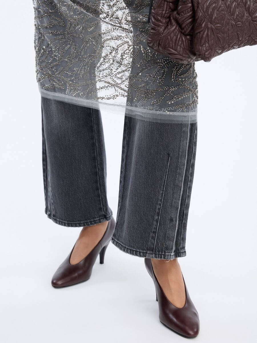 MUNTHE Varika Dress showing raw bottom hem and below knee length over grey jeans with heels