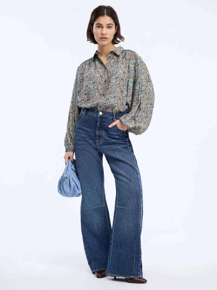 Munthe - Bohdi Jeans - Indigo styled with floral shirt, baby blue leather clutch bag and high heels - showing jean length just off the floor