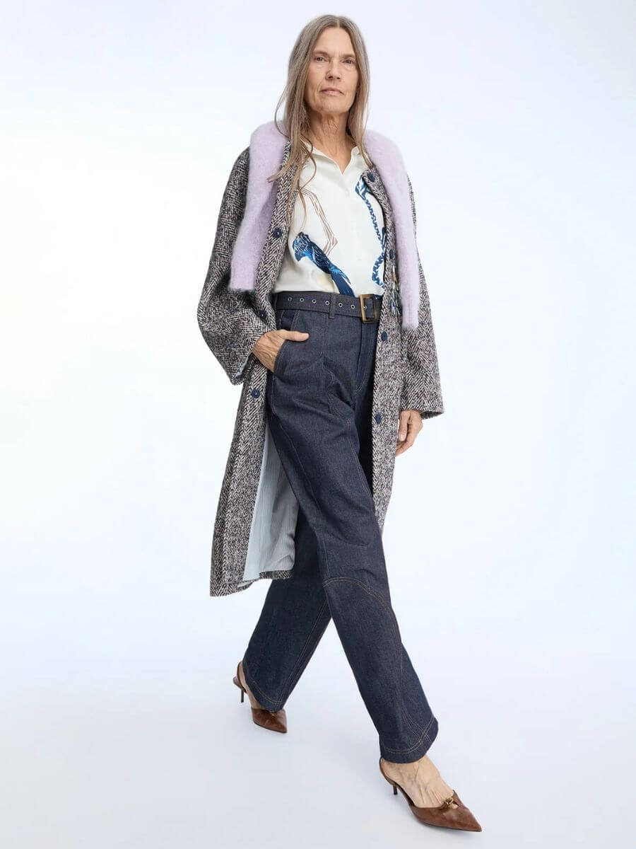 Munthe - Nanina Denim Pants styled with loose patterned shirt, tucked in, grey marl overcoat, brown pointed toe heels and lilac fluffy sweater draped over the shoulders