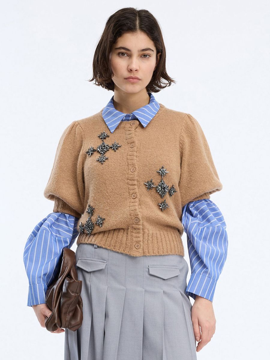 Munthe - Vocca Cardigan styled over a blue/white striped shirt with a grey pleated skirt and brown leather clutch bag