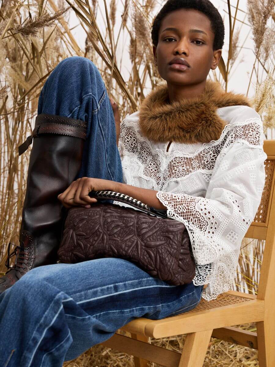 Munthe - Voida Collar over white lace embroidery top and Bohdi jeans with embossed leather clutch bag